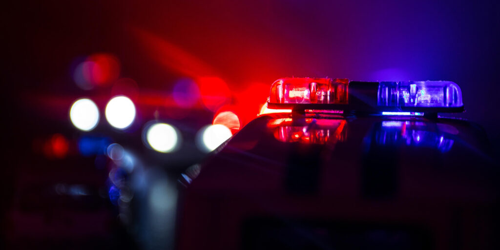 flashing police lights at the scene of a crash in Bakersfield